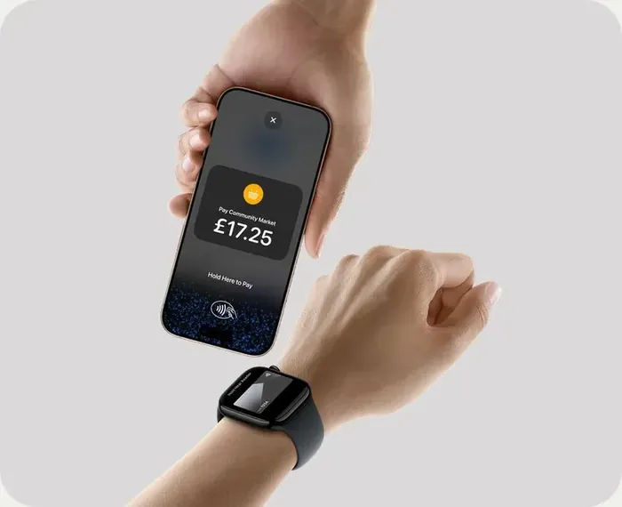 A phone taking a contactless payment from a watch